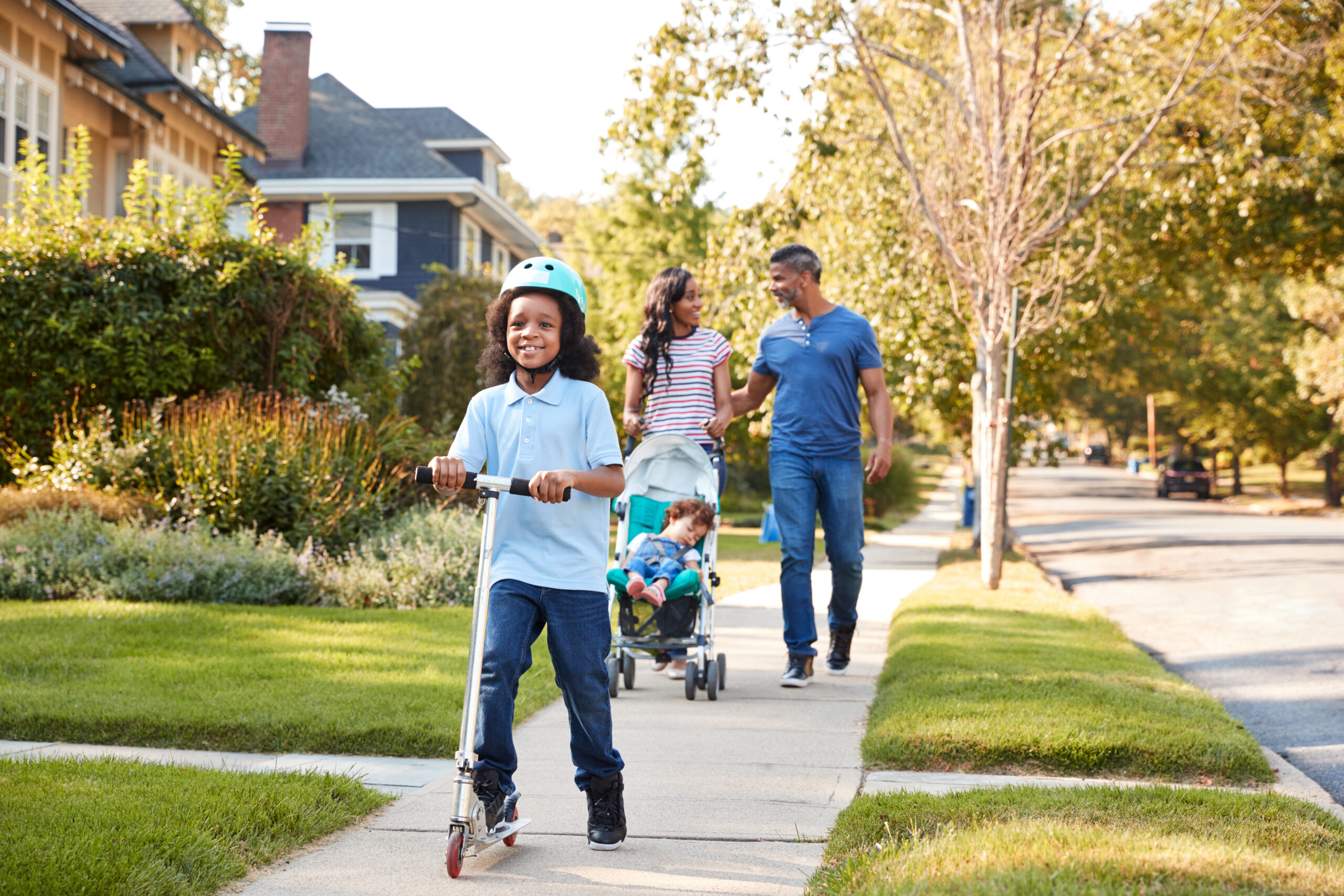 black family walking down the sidewalk in beautiful neighborhood, housing market projections